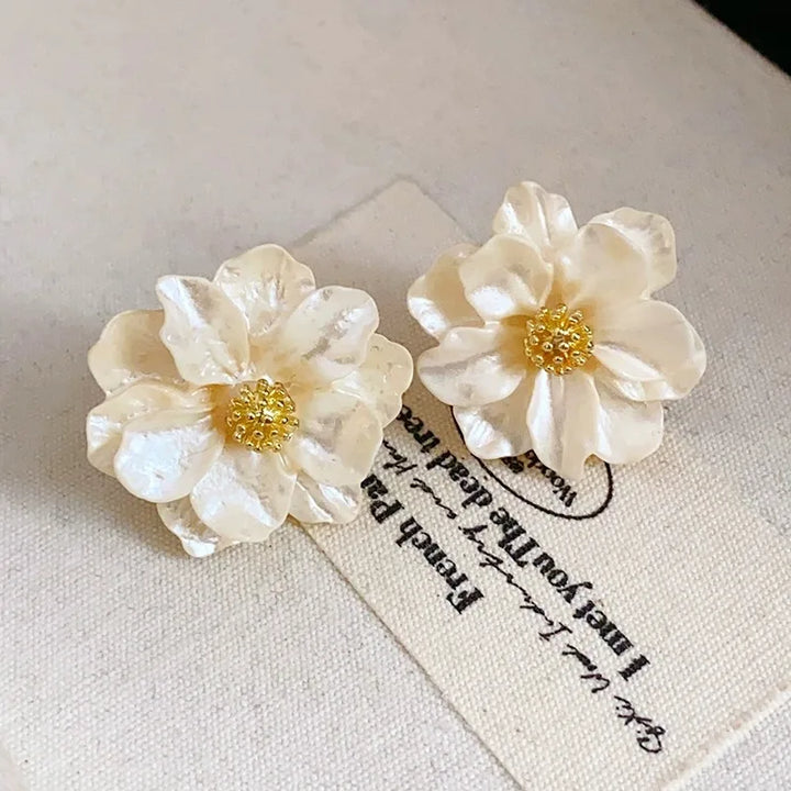 Élégantes boucles d'oreilles en acrylique blanc avec motif floral